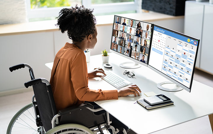 Image of office worker sitting at a computer